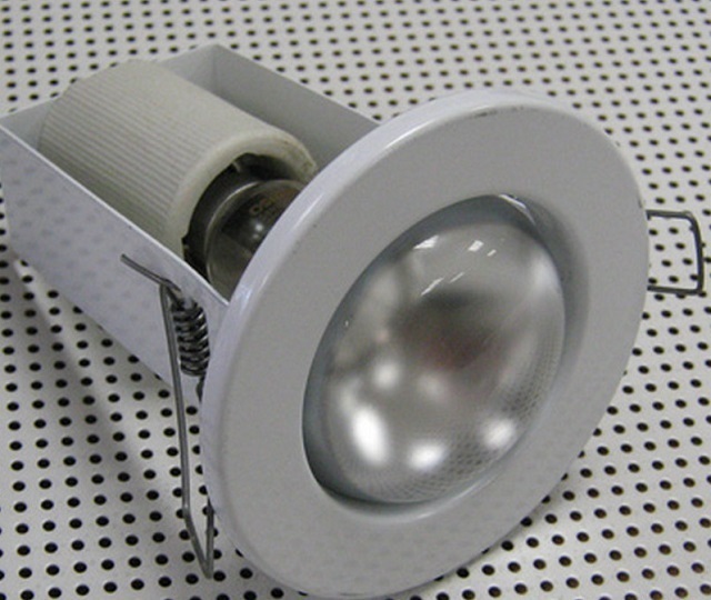 Типичная схема фиксации точечных светильников в прорезанных для них проемах – за счет пружинных «ушек» по бокам