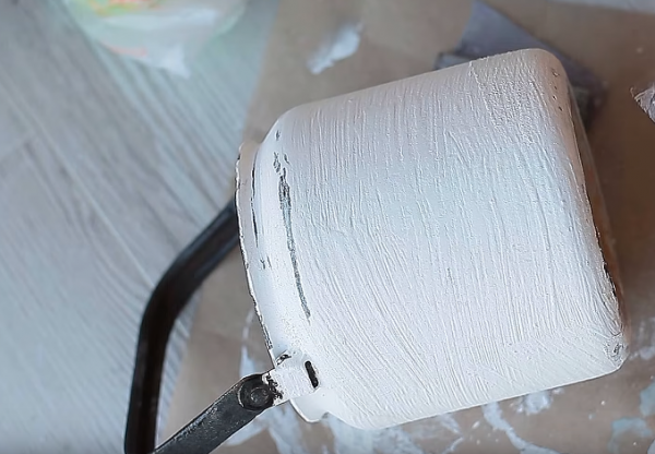 Когда поверхность полностью просохнет, ее затирают при помощи наждачной бумаги до гладкого состояния. Местами необходимо, чтобы проглядывала черная краска для создания эффекта старины